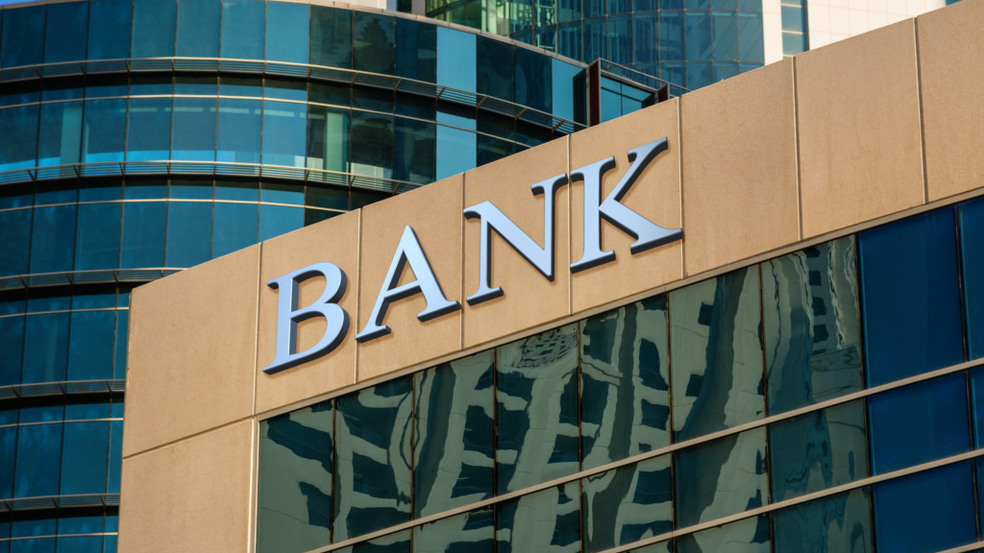 Bank sign on glass wall of business center Bank sign on glass wall of business center
